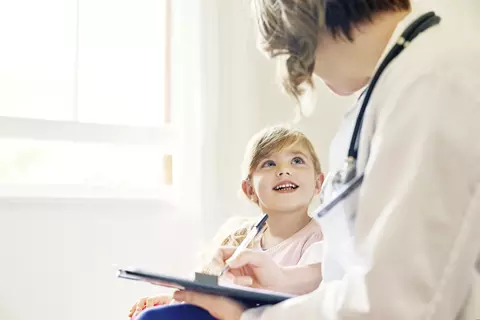 child looking at doctor